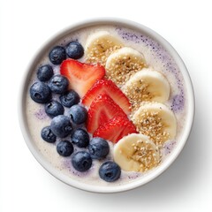Overhead shot of a white bowl filled with a creamy smoothie and arranged fruit toppings