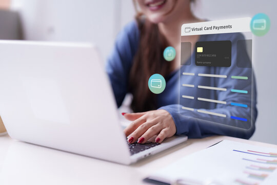 Asian adult woman managing secure virtual card payments laptop computer processing online financial transaction digital banking e-commerce technology - Powered by Adobe