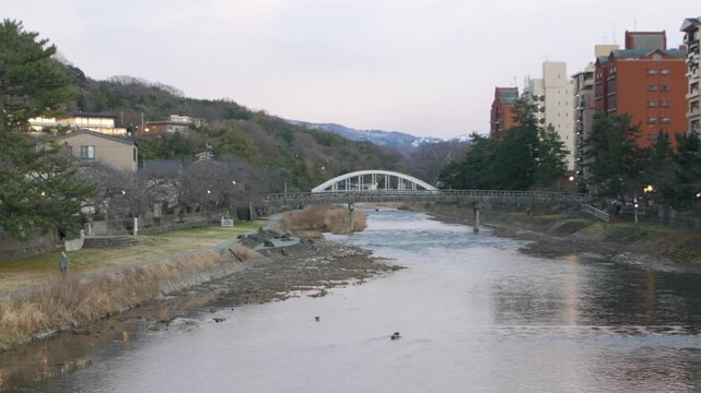 landscape view of river through city of Kanazawa with bridge cross over river in Kanazawa city in sunset sundawn time. view of Kanazawa city with river through town