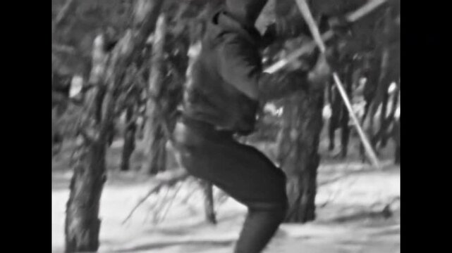 Skier moves quickly, falling on skis down snow covered mountain slope. Professional athlete kicker trains, learns freestyle tricks. Comic winter vacation. Old film. Archival retro. Vintage archive
