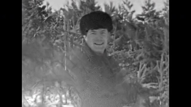 Active man skier portrait practices cross-country skiing in winter forest, climbs snow covered hill. Extreme sport lifestyle in snowy forest. Recreation old film. Archival retro. Vintage archive ski
