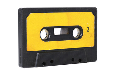 Fototapeta premium Old yellow cassette tape with music tracks from the past isolated on white background.