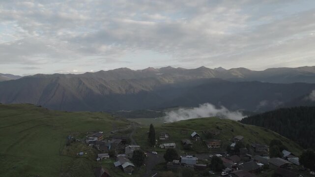 Aerial view of Upper Omalo village and the Keselo fortress at sunset, the mountain landscape in Tusheti, Georgia.