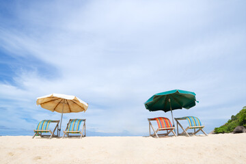 Colorful Loungers and umbrellas on a sandy shoreline, with bright skies, tropical atmosphere, and serene beaches &mdash; perfect for tourism brochures, vacation advertisements, and destination marketing.