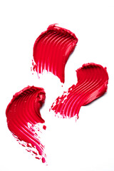 Textured red lipstick or paint swatches isolated on white.