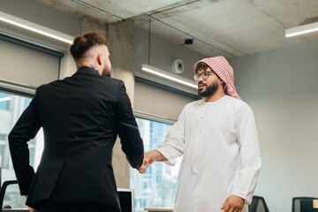 Diverse businessmen shaking hands on agreement