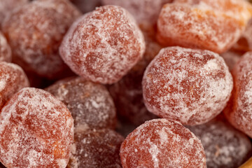 dry fruits of fragrant kumquat dried in sugar syrup, food details, round dehydrated kumquat fruit in a wooden bowl