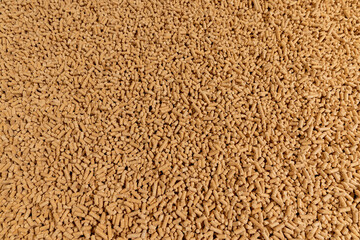 a large number of cylindrical fuel pellets made from sawdust of coniferous spruce or pine trees, the pellets are used both for indoor heating and for bedding for pets, wood pellets