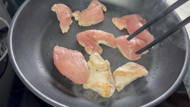 Chicken breast. Cooking lean chicken fillet in a frying pan.