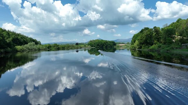 Ireland Epic locations drone chasing speedboat on Blackwater River on Waterford Cork border boat wake on salmon fishing river and beauty spot