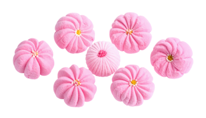 Seven pink, flower-shaped confections are arranged centrally against a black background in a slightly curved layout