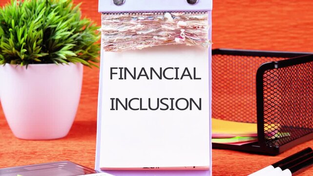 Animation of the FINANCIAL INCLUSION text. The appearance of the FINANCIAL INCLUSION symbol on the desktop calendar, the concept of business and financial literacy. Animated Vide.