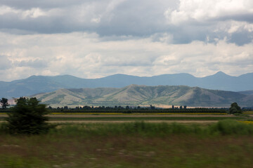Fototapeta premium Mountain,field and dramatic sky