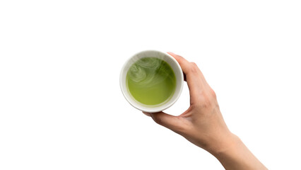 A hand holding a hot ceramic cup of green tea