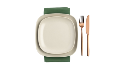 Isolated place setting with green napkin and copper utensils against a plain backdrop