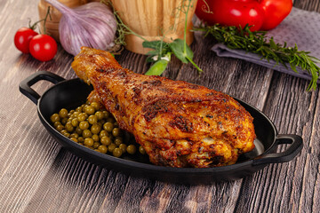 Baked turkey drumstick served green peas
