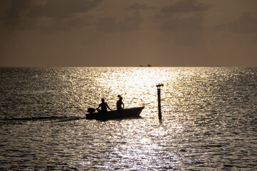 Silhouette of Fishing Boat at Sunset