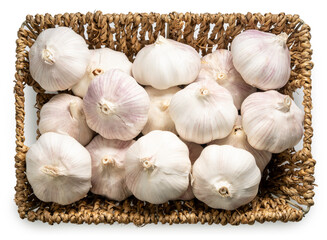 Fresh garlic bulbs in woven bamboo basket isolated on white background with clipping path.