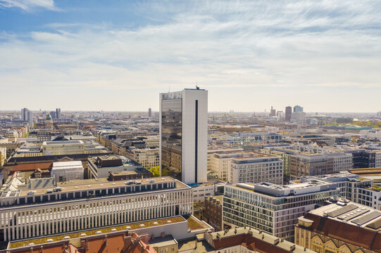 Aerial view of a modern cityscape where buildings rise against a soft, light blue sky, highlighting the architectural contrast between old and new structures, Berlin Mitte, Berlin, Germany.