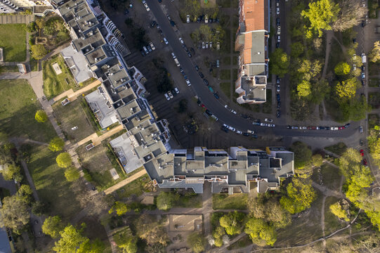Aerial view of buildings casting shadows along the tree-lined streets, a symmetrical dance of urban architecture, Berlin Mitte, Berlin, Germany.