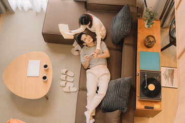 Happy Asian couple enjoying time together in their new home