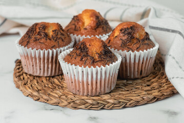 Closeup of homemade chocolate muffins and kitchen cloth