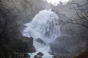 Belelle river waterfall flowing over rocks and mist
