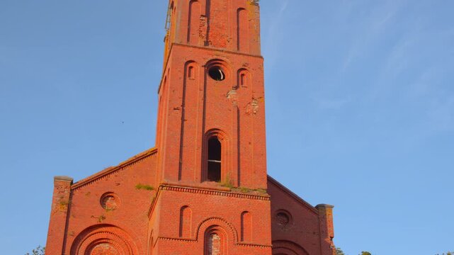 Historic Church Imagery, Heritage Building With Mossy Bricks And Detailed Bell Tower Under Sunny Sky. Media