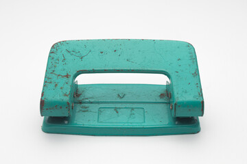 Old Rusty Teal Two-Hole Paper Punch Isolated on White Background