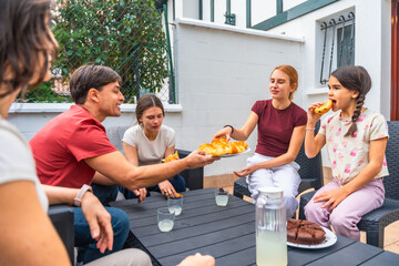 Family sharing snack time outdoors on patio