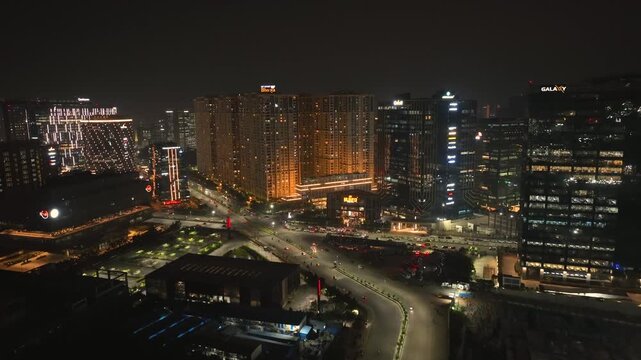 Aerial view of buildings with lights illuminating the roads at night, creating a stunning contrast, Hyderabad, Telangana, India.