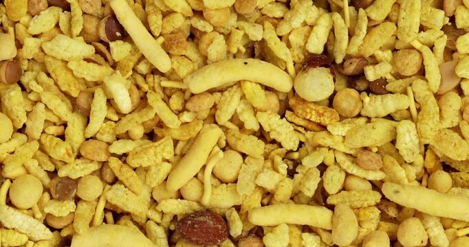 Traditional indian deep fried salty dish - chivda or farsan or namkeen made of gram flour and mixed with dry fruits, selective focus