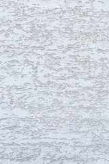 Textured white wall with subtle patterns and variations. The surface appears rough and uneven, creating an interesting visual effect.