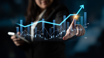 A professional businesswoman engages with digital graphs displaying growth trends, showcasing technology role in analyzing financial data with a modern approach. Scalp