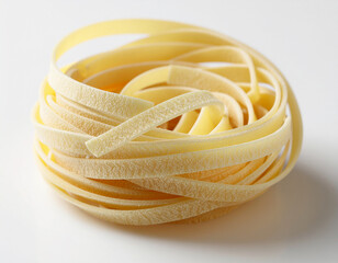 tagliatelle pasta rolled up on a white surface