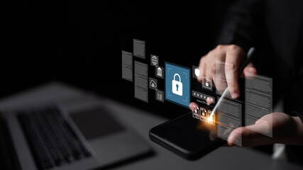 A person uses a smartphone to access security icons and digital interface elements, highlighting the importance of cybersecurity and data protection in the modern digital landscape. Gantry
