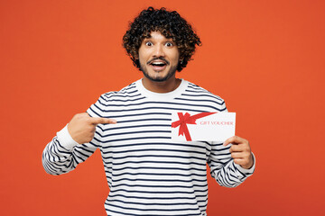 Young surprised happy Indian man wear striped sweatshirt casual clothes hold point on gift...
