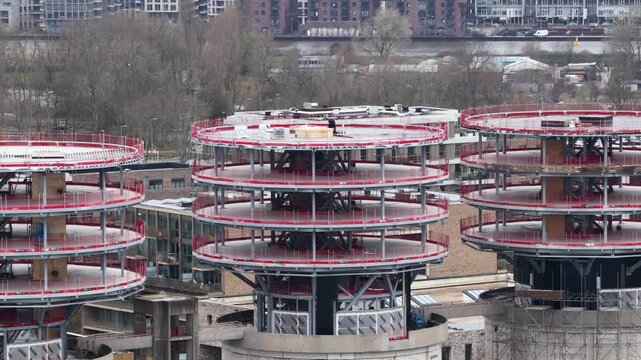 Aerial drone footage showing the redevelopment of the iconic former sewage silos on Zeeburgereiland in Amsterdam, transformed into cinemas, restaurants, workspaces, and public rooftop terraces