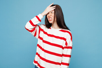 Young sad woman wear red striped sweatshirt casual clothes put hand on face facepalm epic fail mistaken omg gesture isolated on plain pastel light blue background studio portrait. Lifestyle concept.