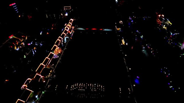 Aerial view of vibrant, illuminated structures creating a mesmerizing scene against the dark canvas of night, Hoa Lu, Ninh Binh, Vietnam.