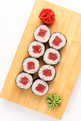 Beautifully crafted sushi rolls displayed on a wooden platter