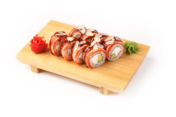 Sushi rolls adorned with slivered almonds on a wooden plate