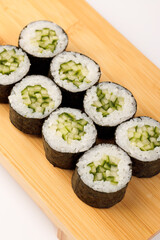 Delightful cucumber rolls arranged on a wooden platter