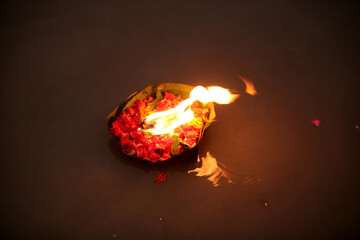 burning candle in the river