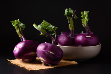 Ripe purple kohlrabi, freshly harvested from an organic farm, placed on a black background, is a healthy ingredient for cooking