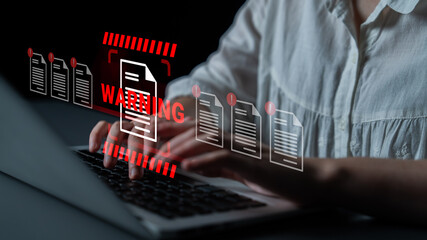 A woman types on a laptop as a warning icon overlays the scene, symbolizing the rising importance of data security and privacy in the digital workspace. Gantry