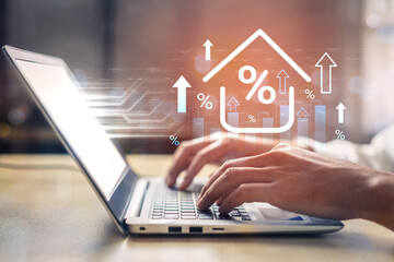 A focused individual types on a laptop while animated graphs and percent symbols overlay the screen, symbolizing financial strategies in a digital workspace. Gantry