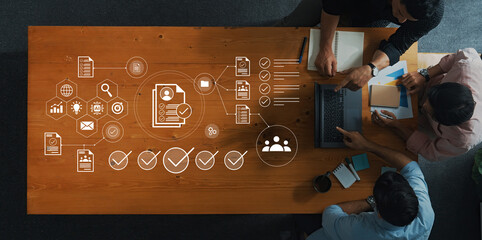 A top view image of people collaborating on project planning and data analysis in a modern office setting, showcasing teamwork and technology integration in business strategy. Gantry