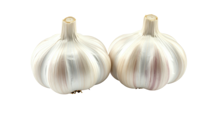 Two bulbs of garlic, close together, with white cloves visible, isolated on a pure black background