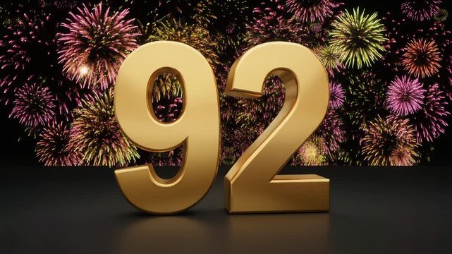 Gold number 92 with fireworks in the background. Festive scene for birthday or anniversary party